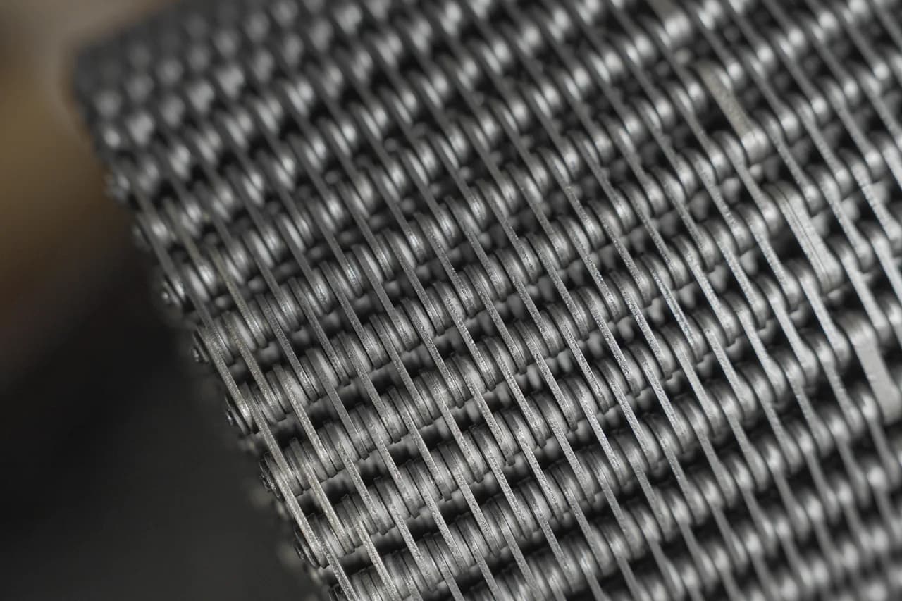 Close view of the plates, pins, and spacers in a conveying chain