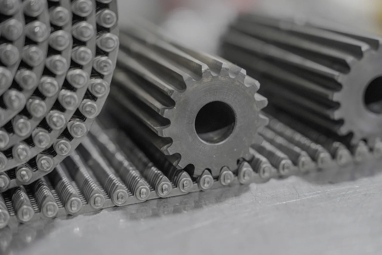 Close view of a sprocket placed beside a conveying-chain profile