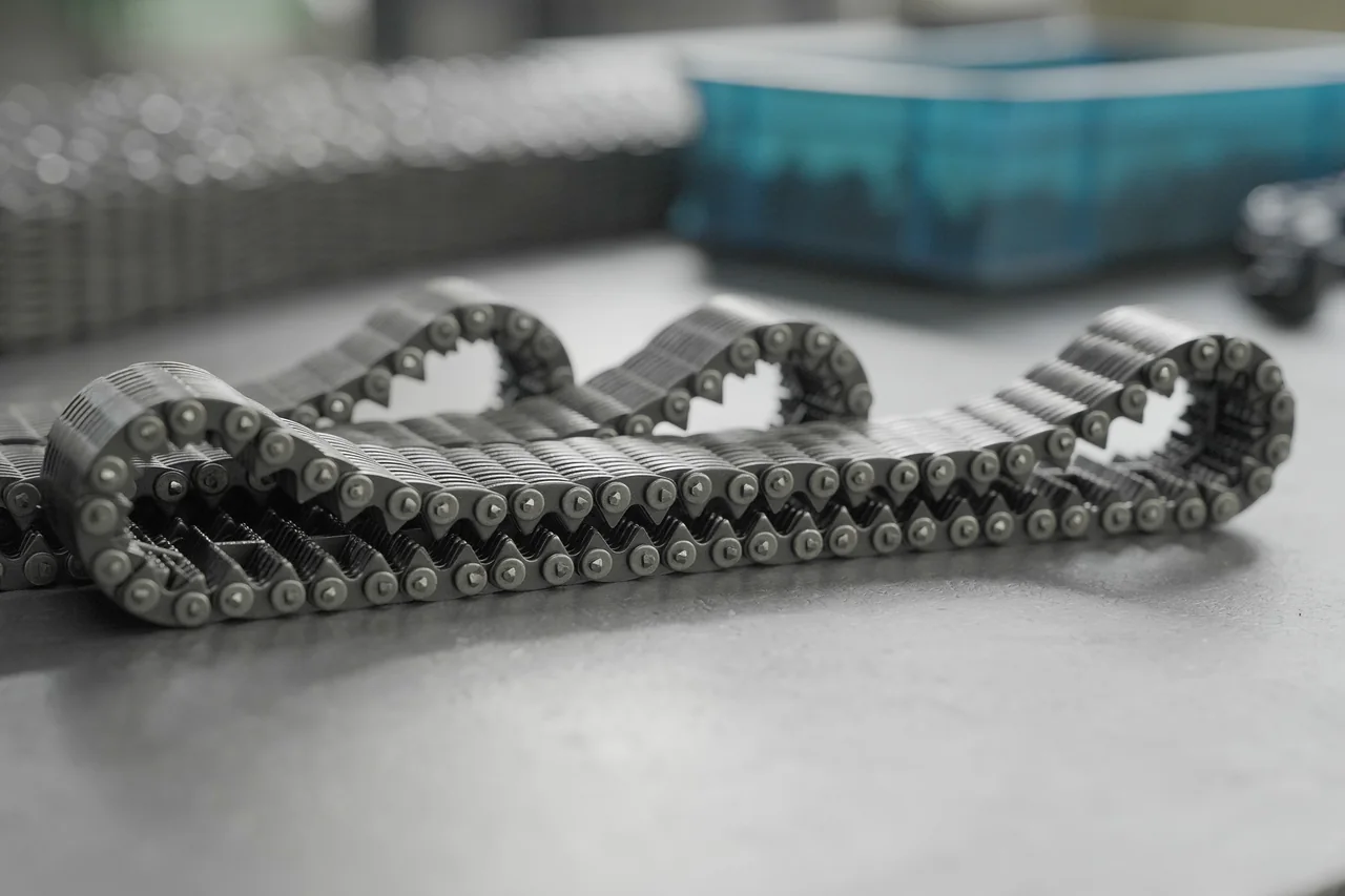 Finished silent chain arranged in a curved profile on a workshop surface