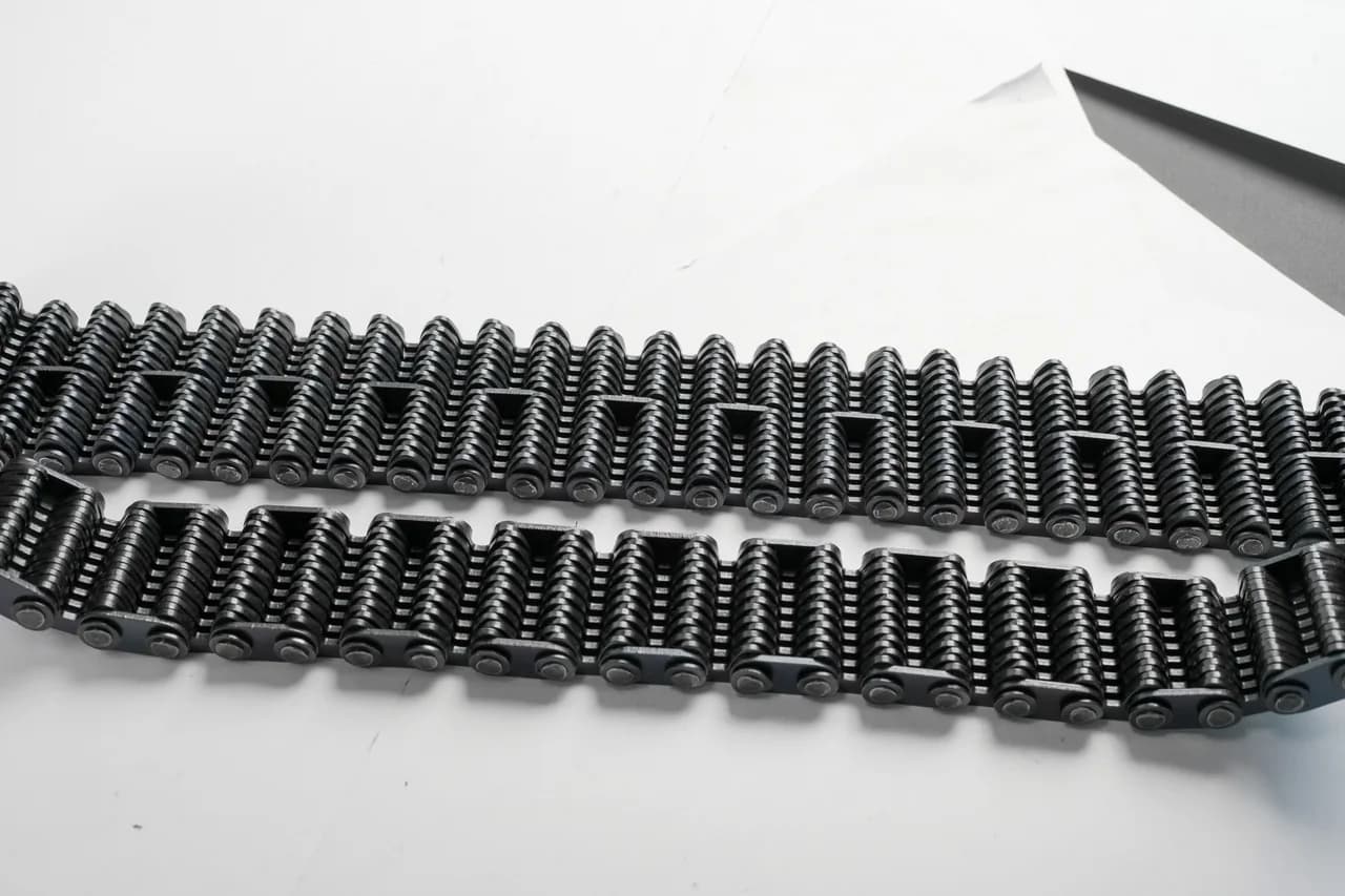 Several silent-chain sections showing different toothed-link profiles