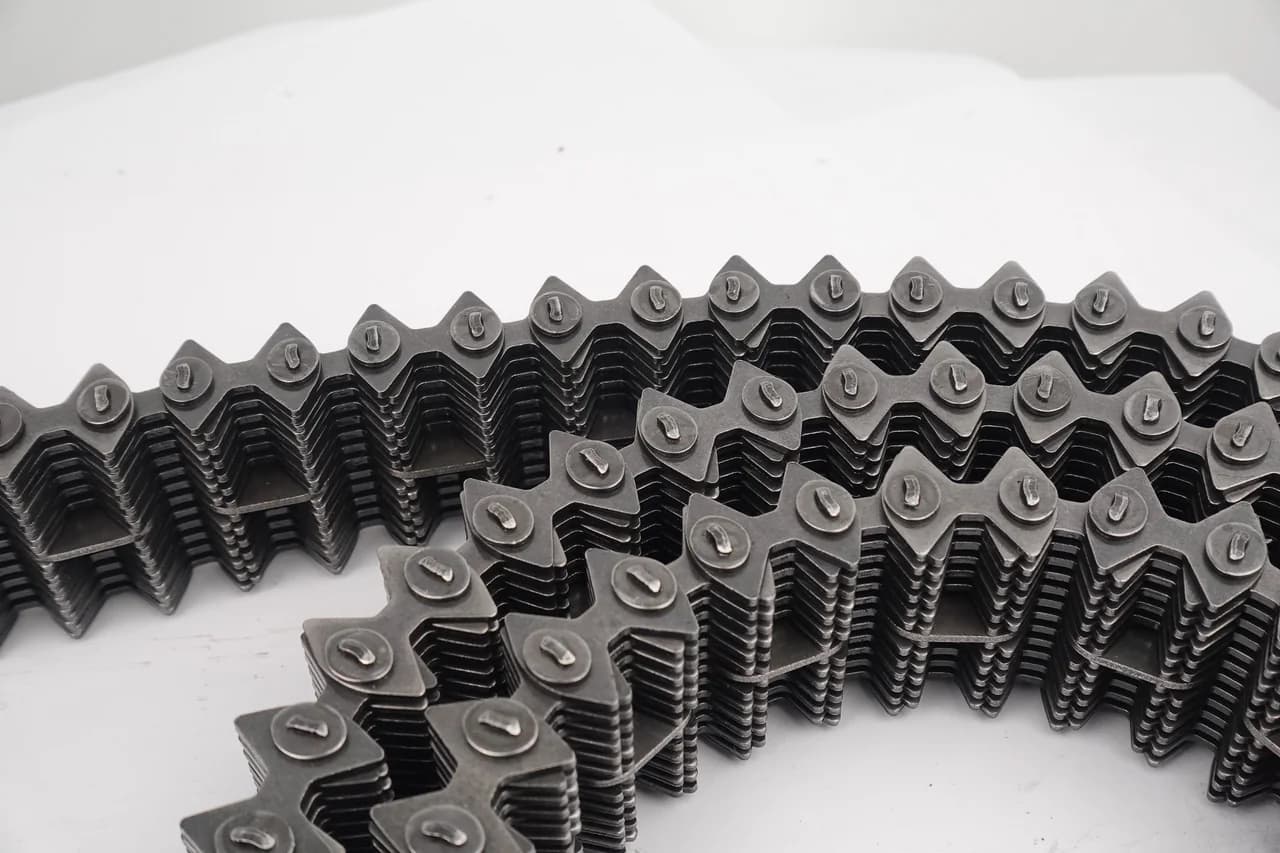 Silent-chain section with toothed profiles visible along both edges