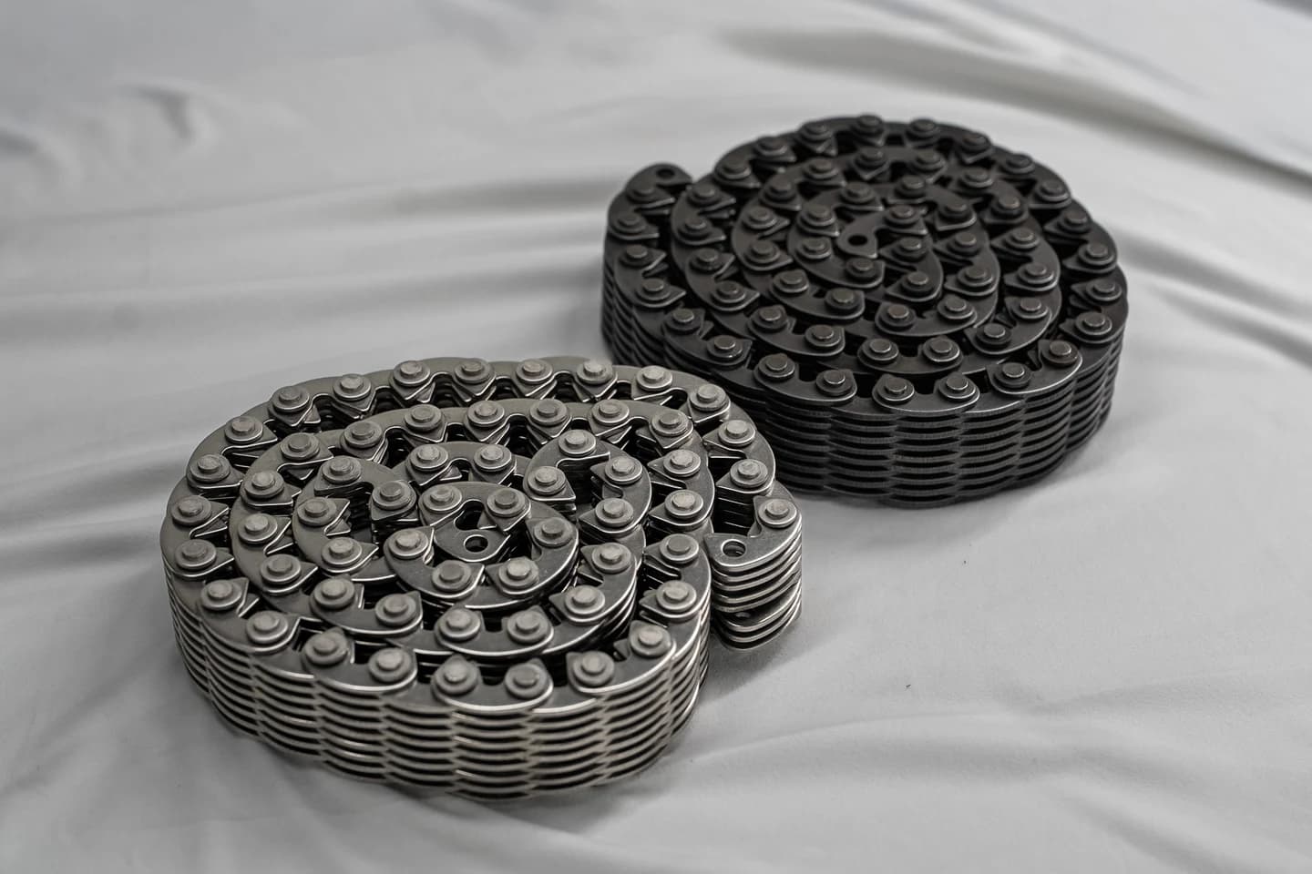 Two coiled silent-chain assemblies arranged on a light work surface