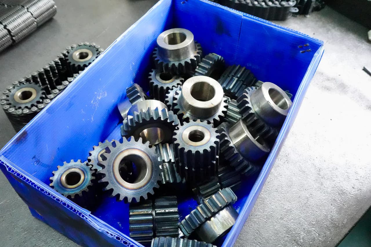 Sprockets with different tooth counts, bores, and hub profiles in a workshop bin