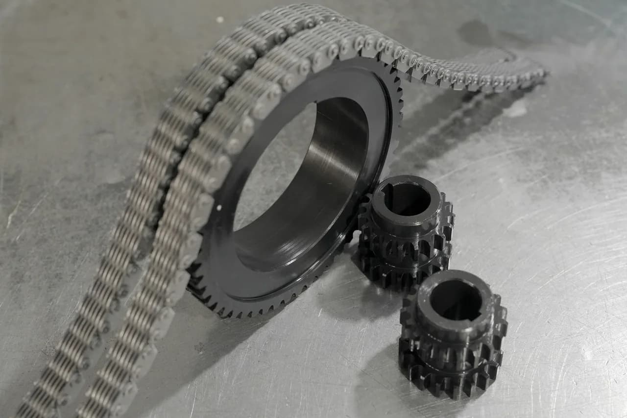 One large sprocket and two smaller sprockets arranged with a chain