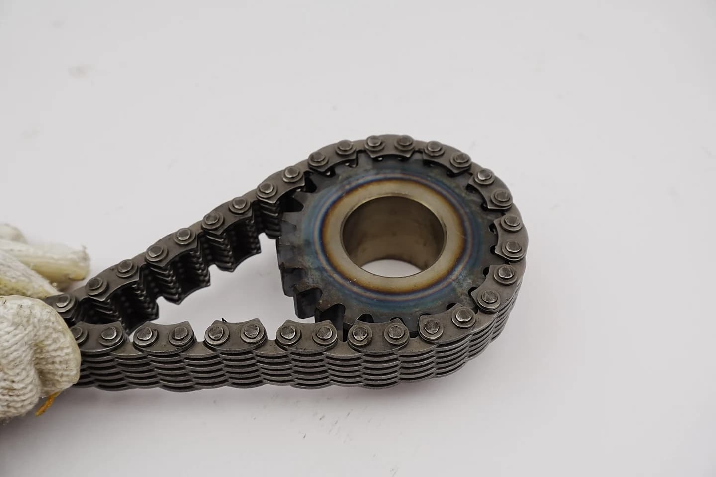 Close view of chain links seated around a sprocket
