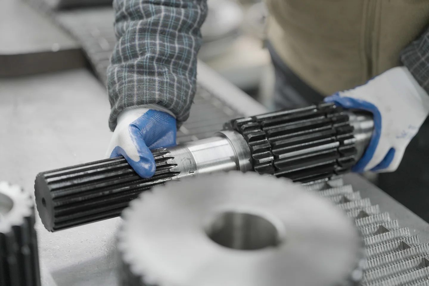 Technician holding chain-system components during a workshop review