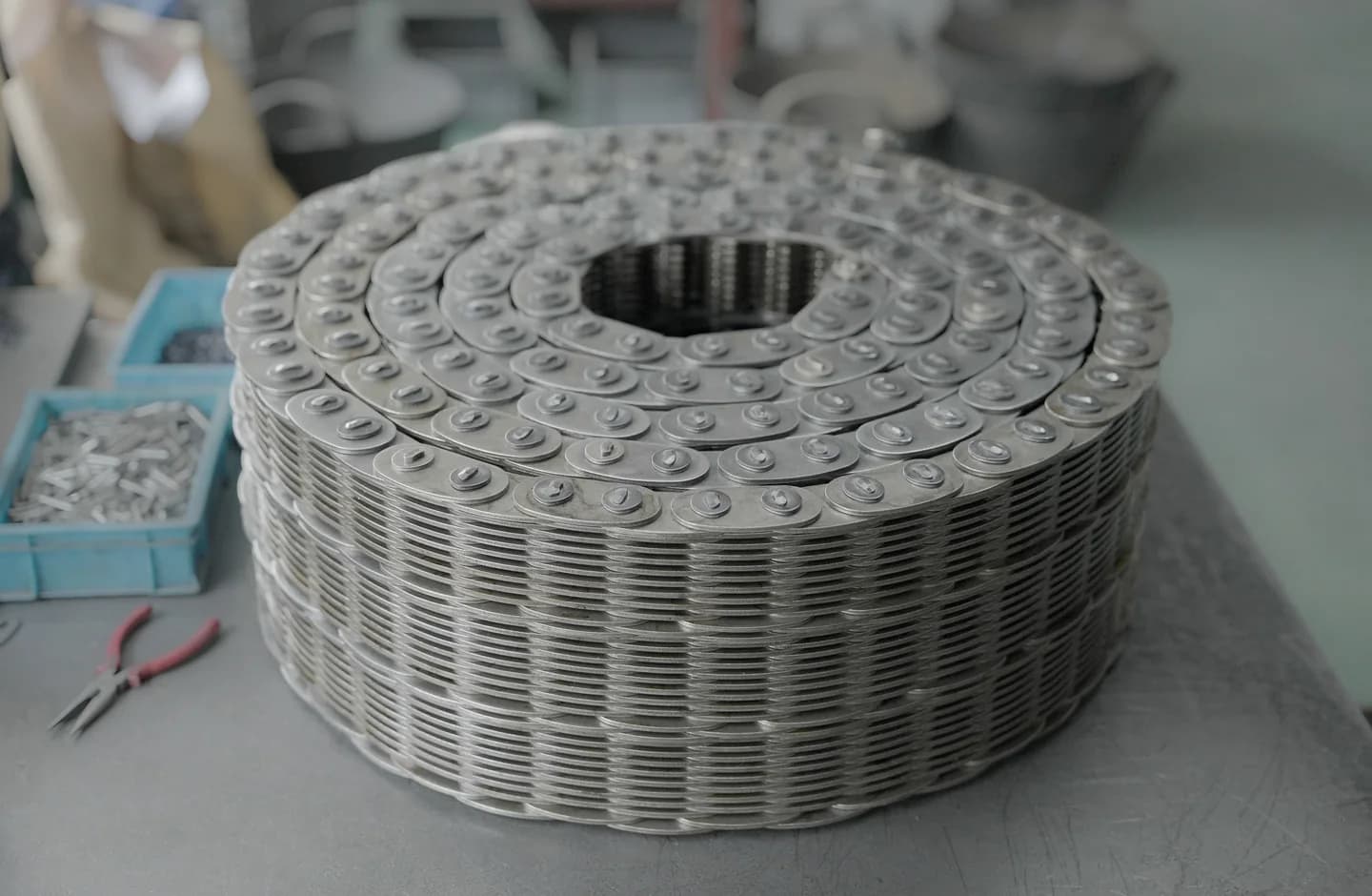 Large finished chain assembly coiled on a workshop table